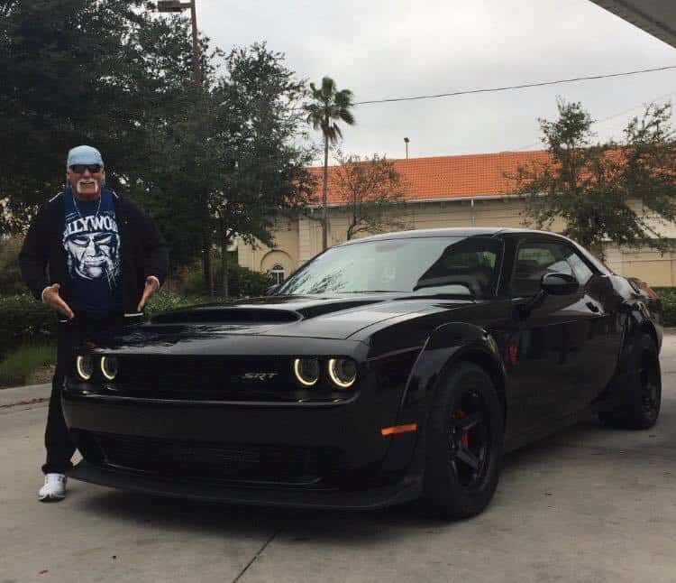 Hulk Hogan posing with his Dodge Challenger Demon, worth $84,995. 