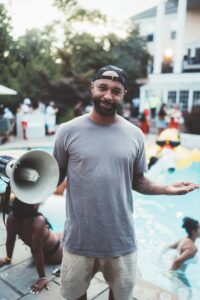 Budden posing during pool party at his mansion