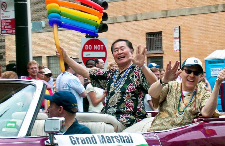 George Riding a Car During Parade (Source: Lions Roar)