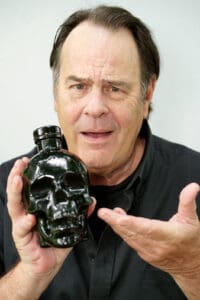 Aykroyd with his Crystal Head Vodka container