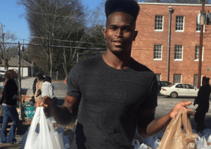 Jones with meal bags to distribute to needy people
