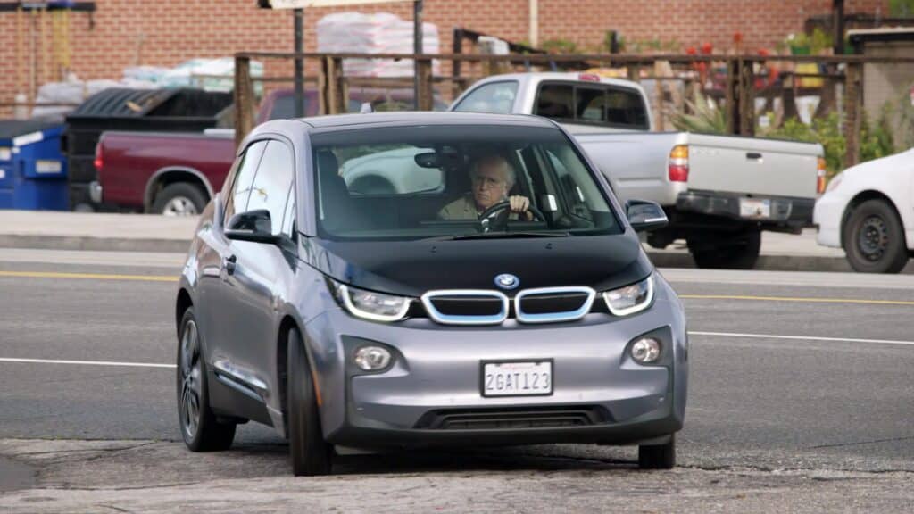 Larry David, photographed driving his BMW i3.