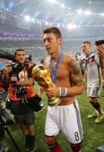 Mesut Ozil with a World cup trophy in his hand after victory over Argentina in 2014.