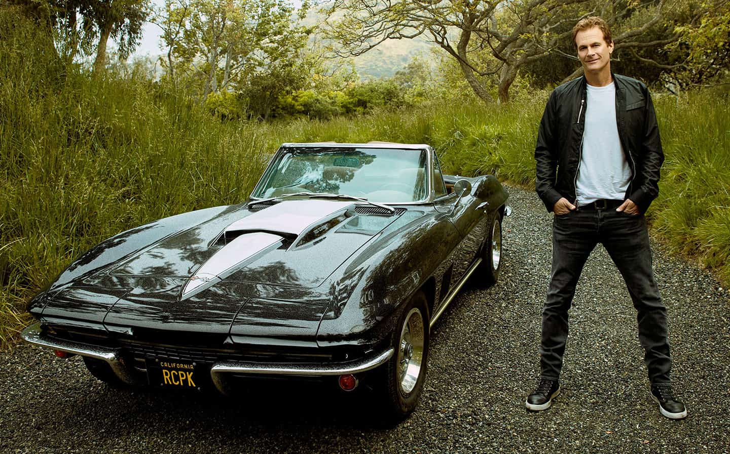 Rande Gerber posing in front of his amazing car.